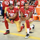 Eric Reid, No. 35, and Colin Kaepernick, No. 7, then of the San Francisco 49ers, kneel in protest during the national anthem prior to playing the Los Angeles Rams in their NFL game at Levi’s Stadium on Sept. 12, 2016, in Santa Clara, Calif.